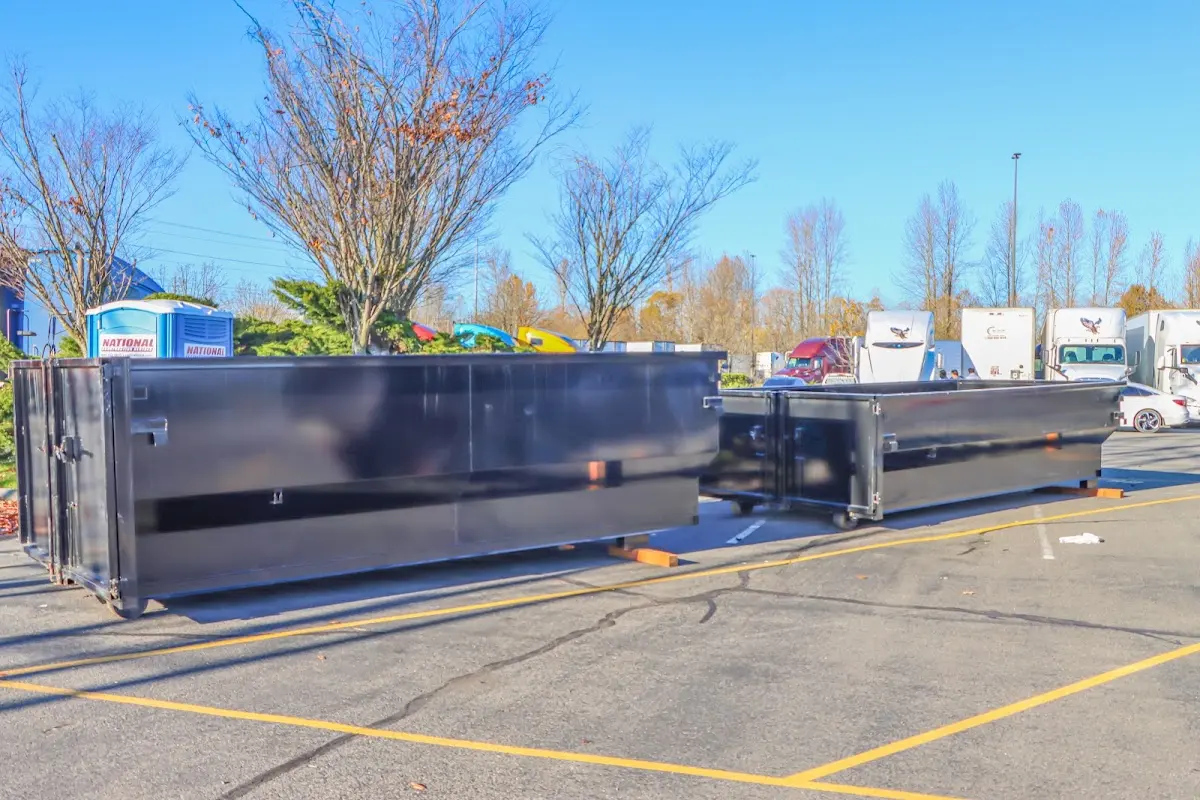 Professional dumpster rental service with roll-off container on residential driveway in Pace